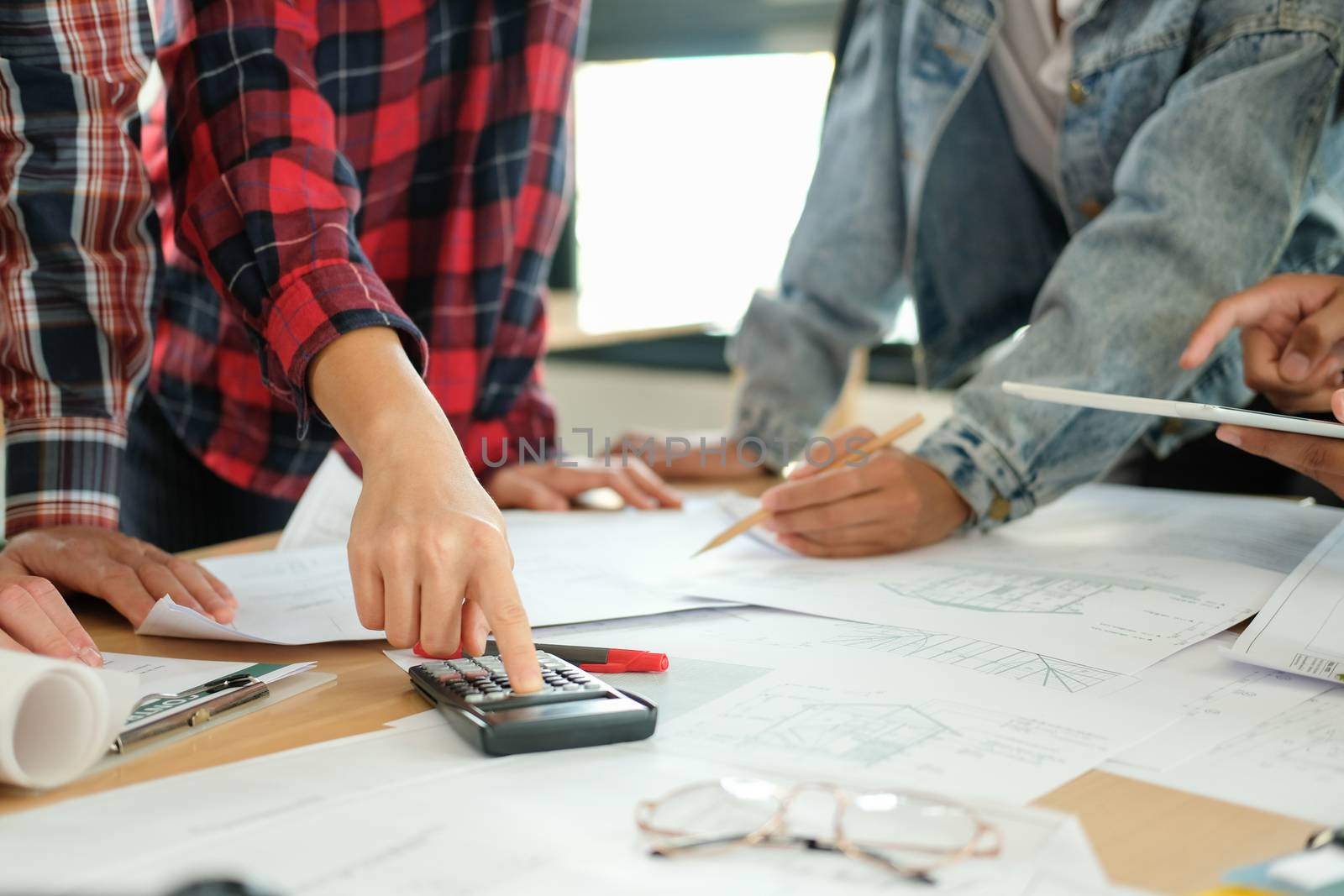 architect engineer interior designer team working discussing on house blueprint of real estate project in meeting. building construction teamwork concept