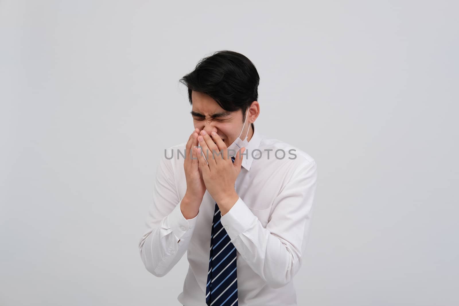 ill businessman man feeling sick, sneezing coughing wearing protective mask against cold flu virus bacteria infection pollution