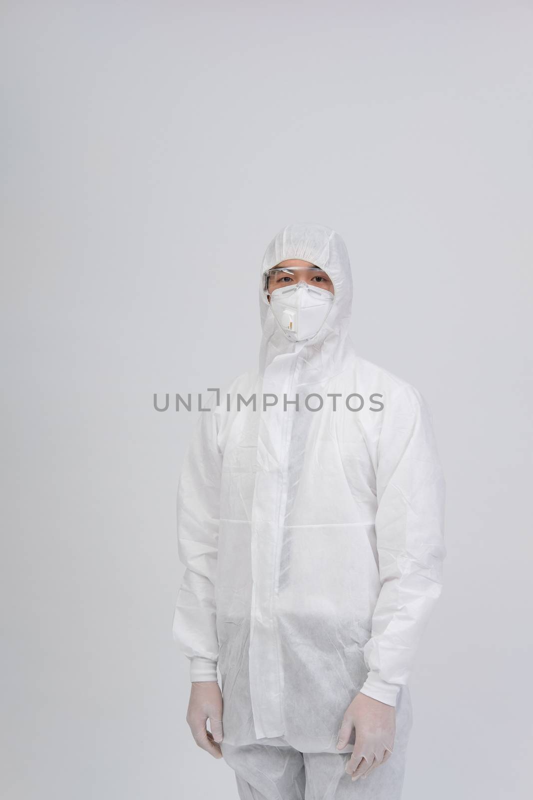 man doctor wearing biological protective uniform suit clothing, mask, gloves for preventing virus bacteria infection contamination