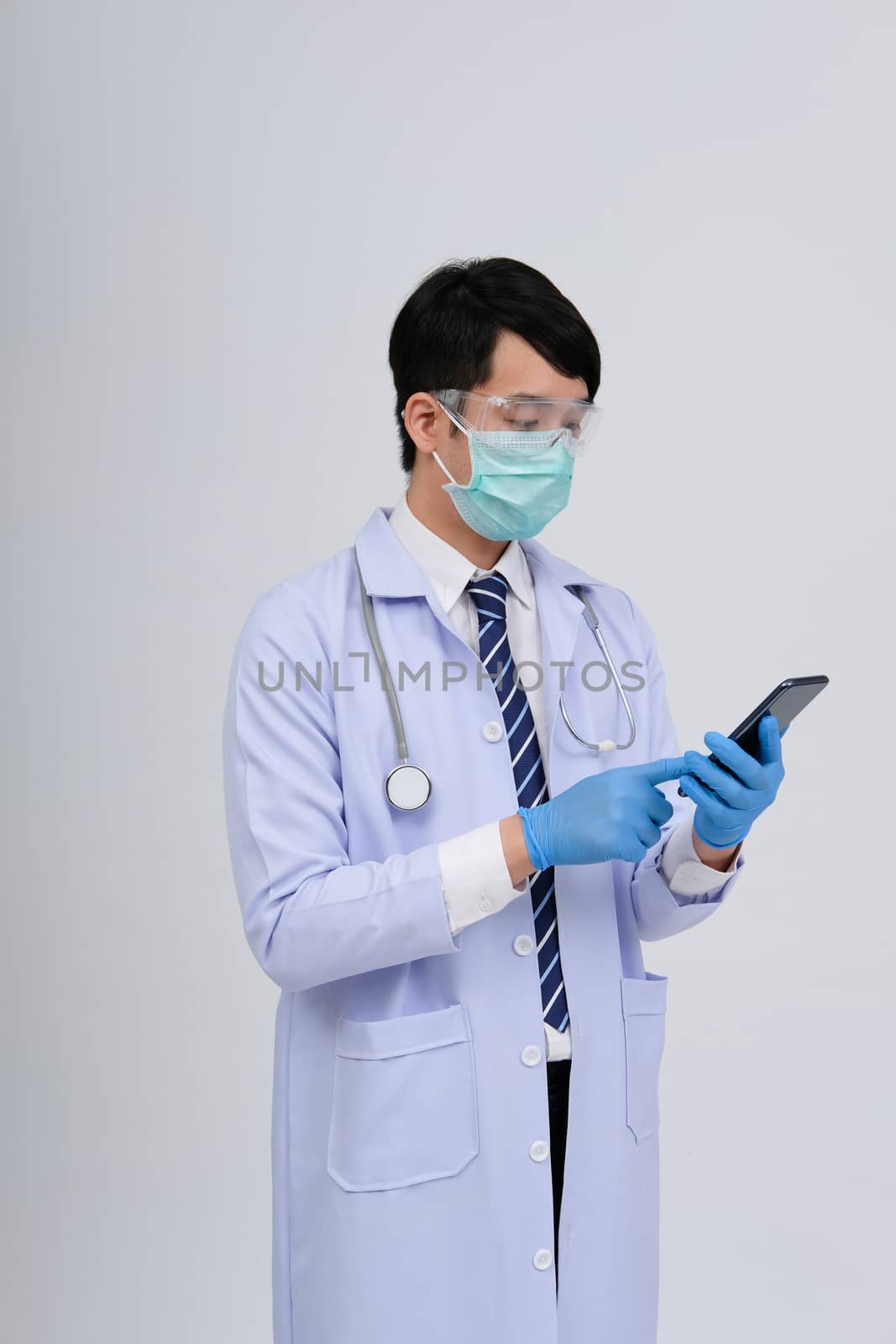 doctor physician practitioner wearing mask with smartphone & stethoscope on white background. medical professional medicine healthcare concept