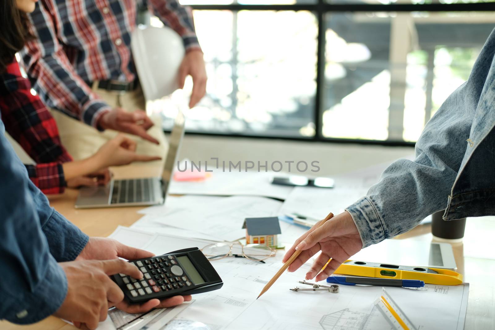 architect engineer interior designer team working discussing on house blueprint of real estate project in meeting. building construction teamwork concept