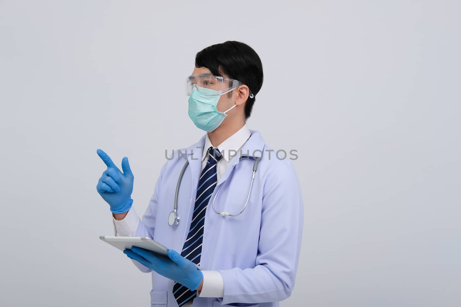 doctor physician practitioner wearing mask with tablet & stethoscope on white background. medical professional medicine healthcare concept