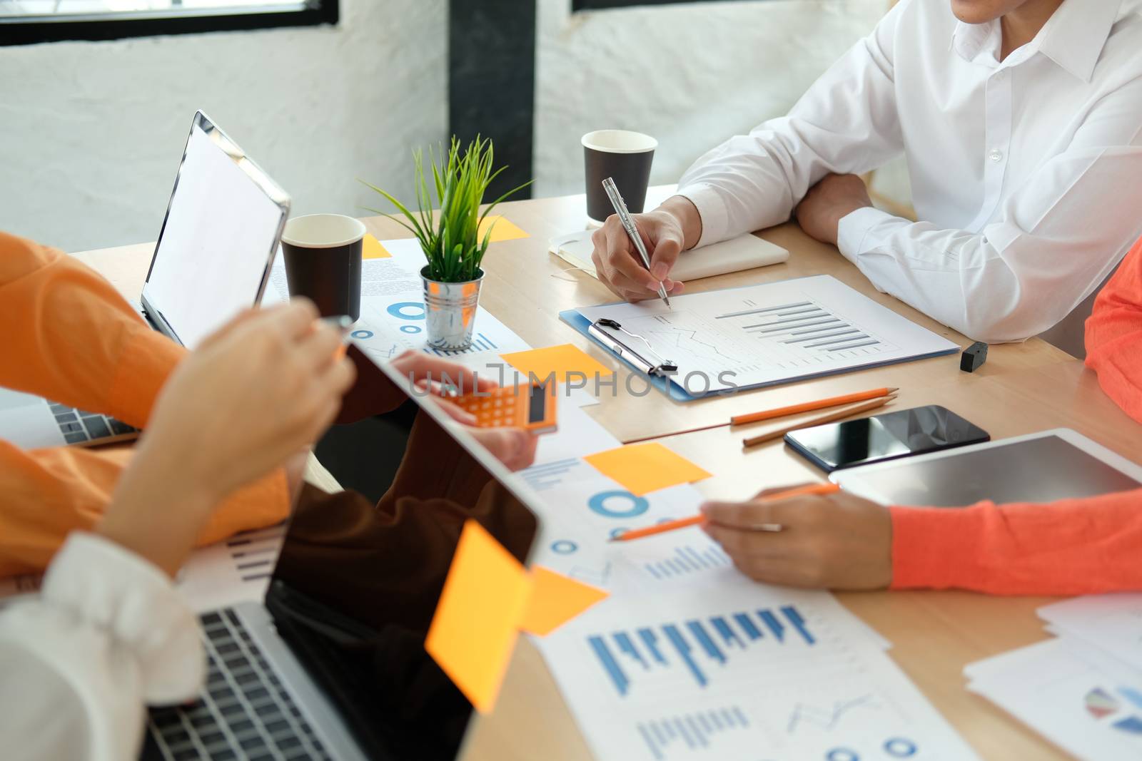business people discussing on performance revenue in meeting. businessman working with co-worker team. financial adviser analyzing data with investor.
