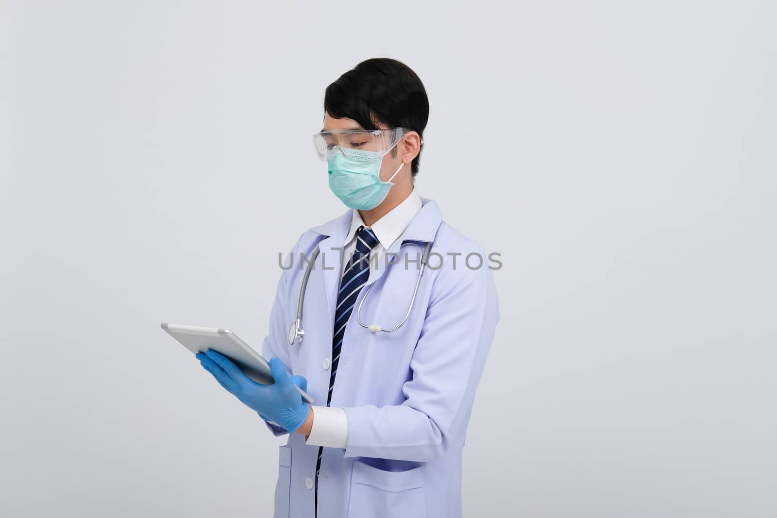doctor physician practitioner wearing mask with tablet & stethoscope on white background. medical professional medicine healthcare concept