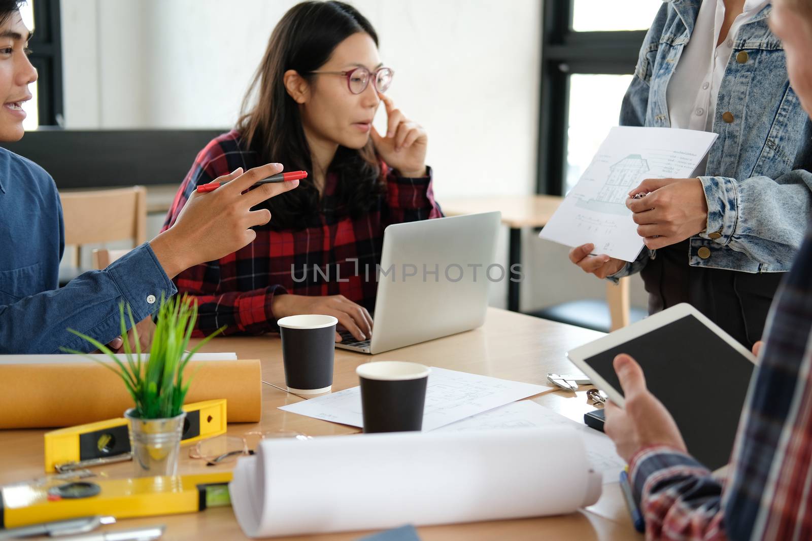 architect engineer interior designer team working discussing on house blueprint of real estate project in meeting. building construction teamwork concept