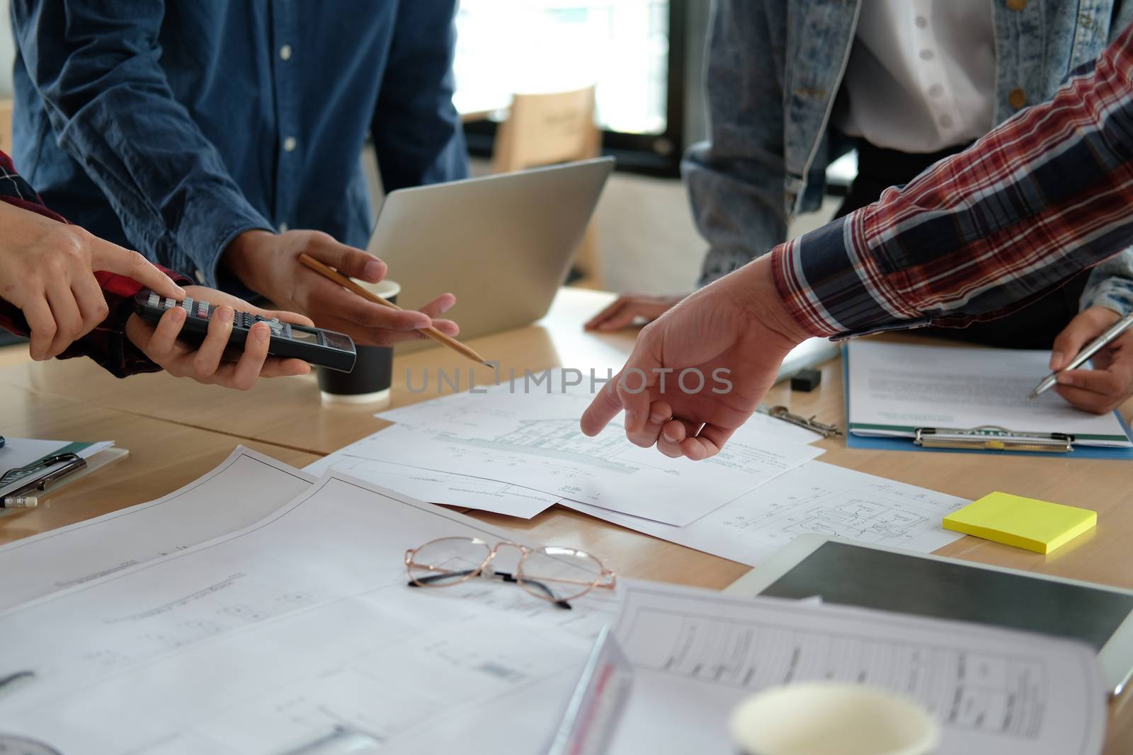 architect engineer interior designer team working discussing on house blueprint of real estate project in meeting. building construction teamwork concept