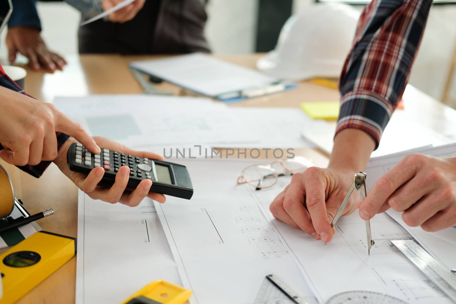 architect engineer interior designer team working discussing on house blueprint of real estate project in meeting. building construction teamwork concept