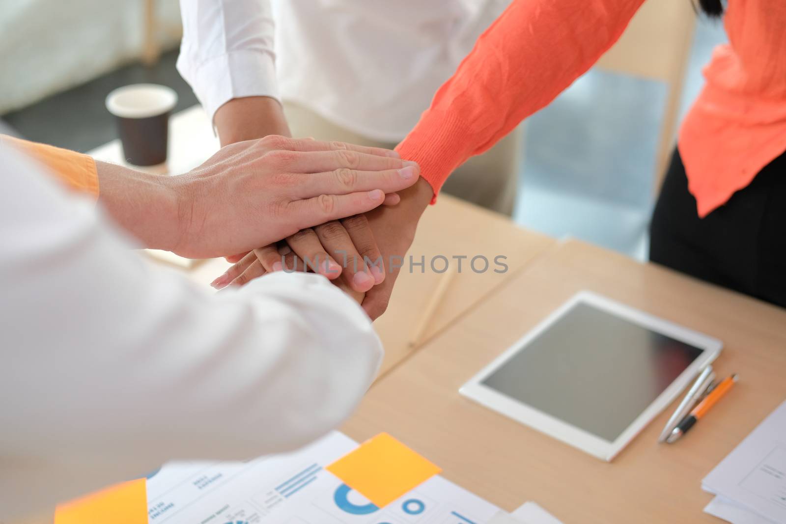 startup man woman joining united hand, business team touching hands together after complete a deal in meeting. unity teamwork partnership corporate concept.