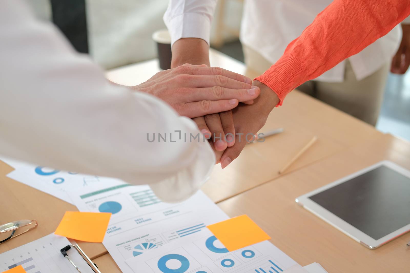 startup man woman joining united hand, business team touching hands together after complete a deal in meeting. unity teamwork partnership corporate concept.