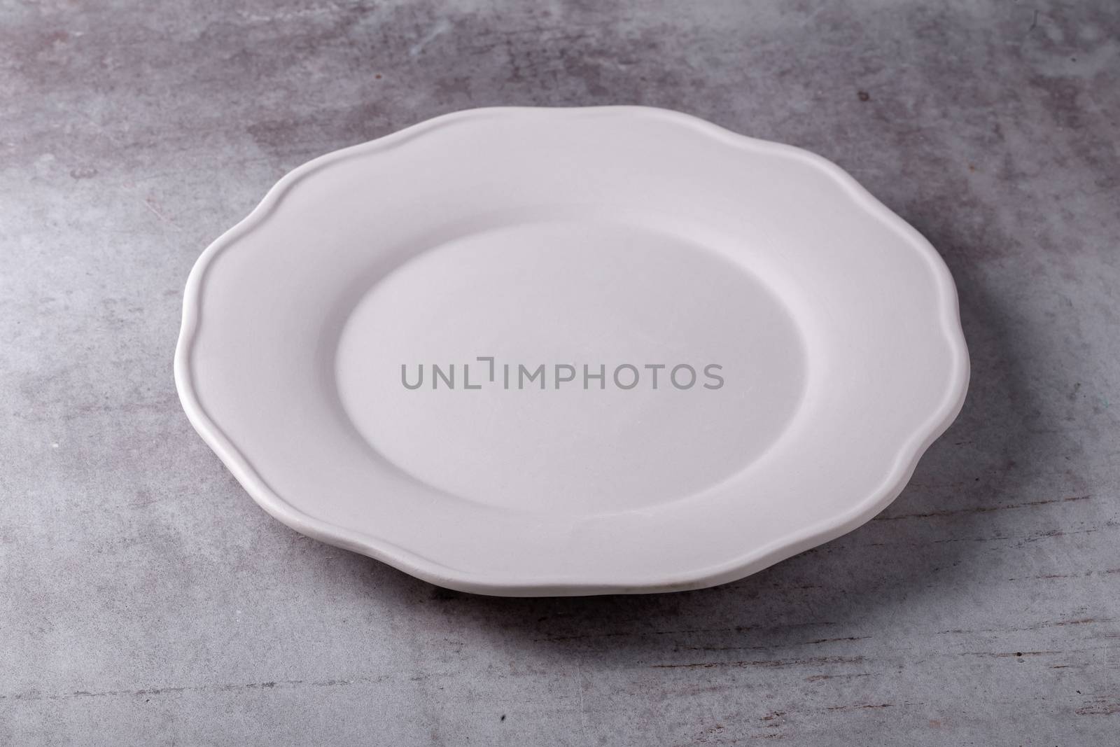 Empty blank white ceramic dish on Cement Board by kaiskynet