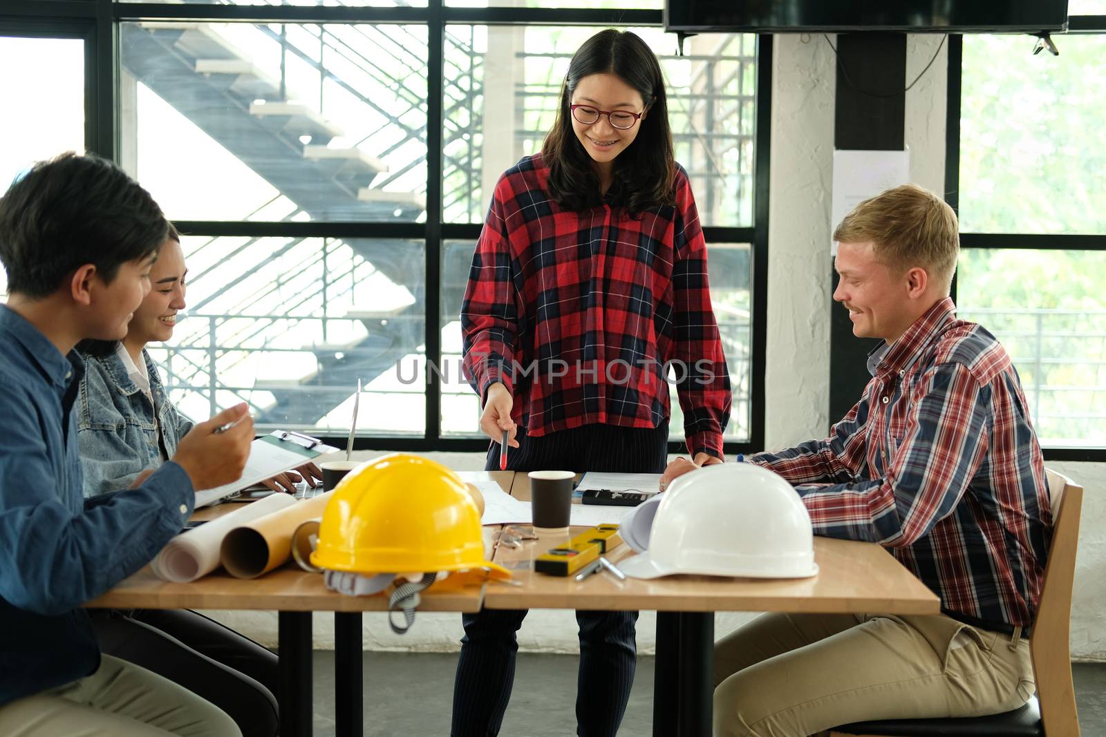 architect engineer interior designer team working discussing on house blueprint of real estate project in meeting. building construction teamwork concept