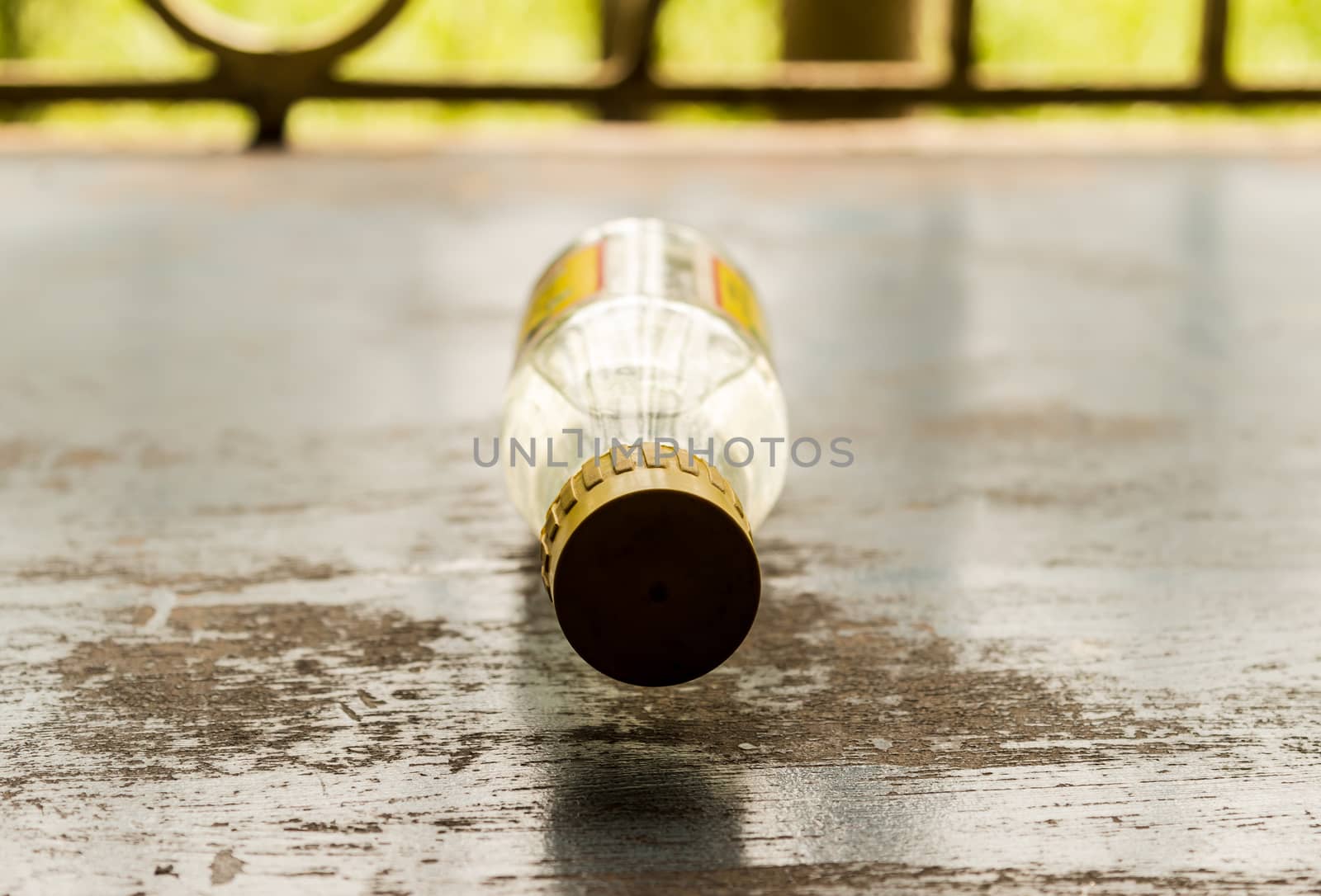 Glass bottle Lying on rustic floor. Still Life. Selective focus. Shallow depth of field.