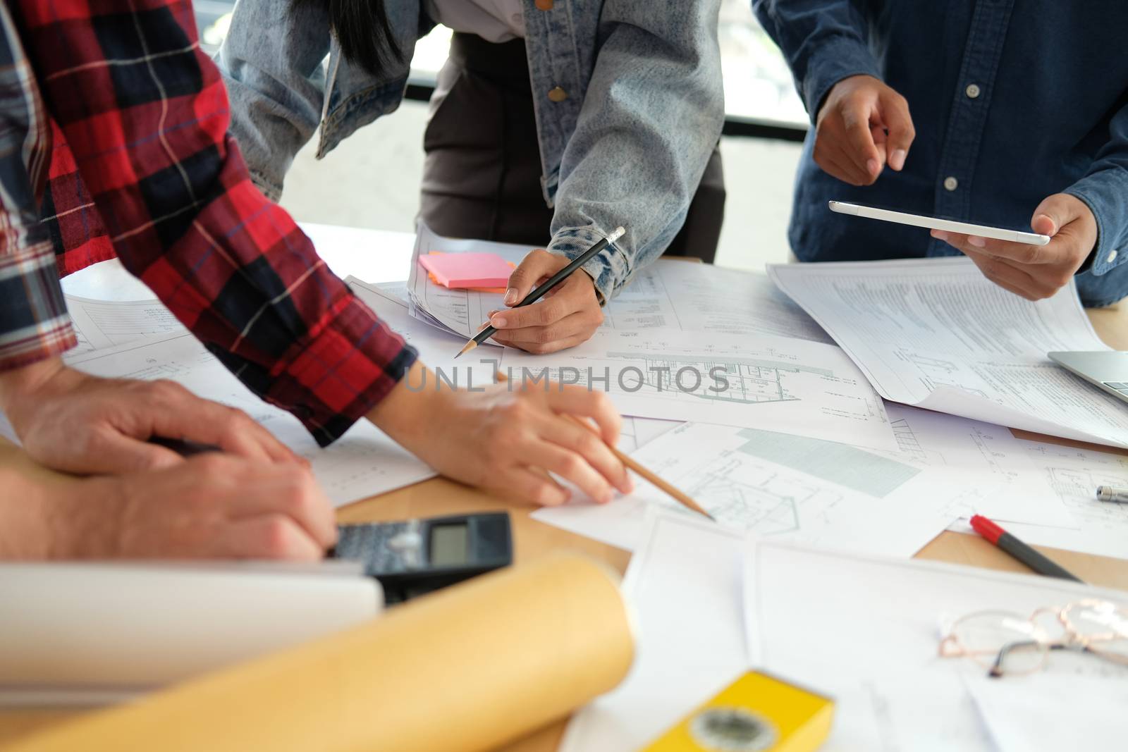 architect engineer interior designer team working discussing on house blueprint of real estate project in meeting. building construction teamwork concept