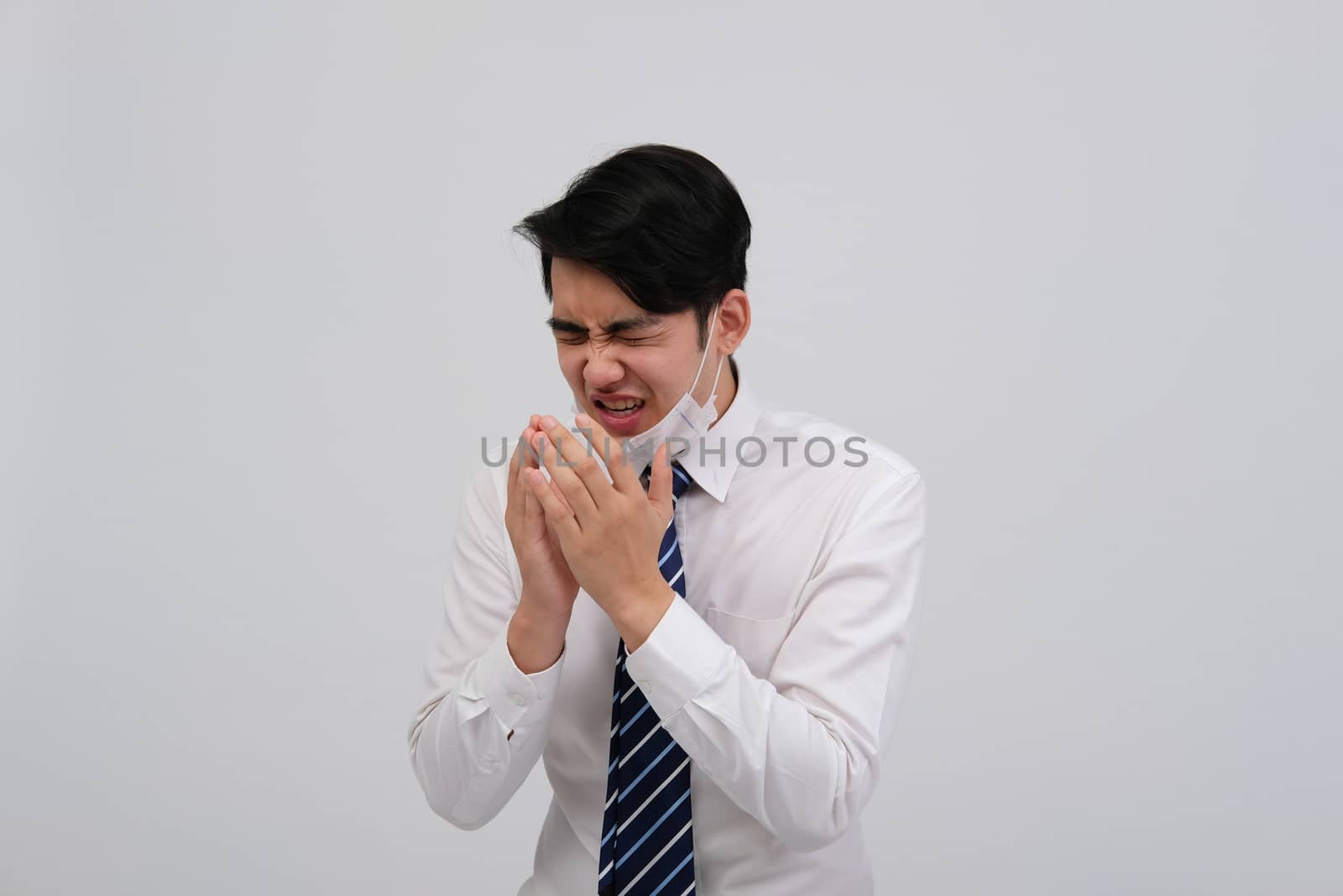 ill businessman man feeling sick, sneezing coughing wearing protective mask against cold flu virus bacteria infection pollution