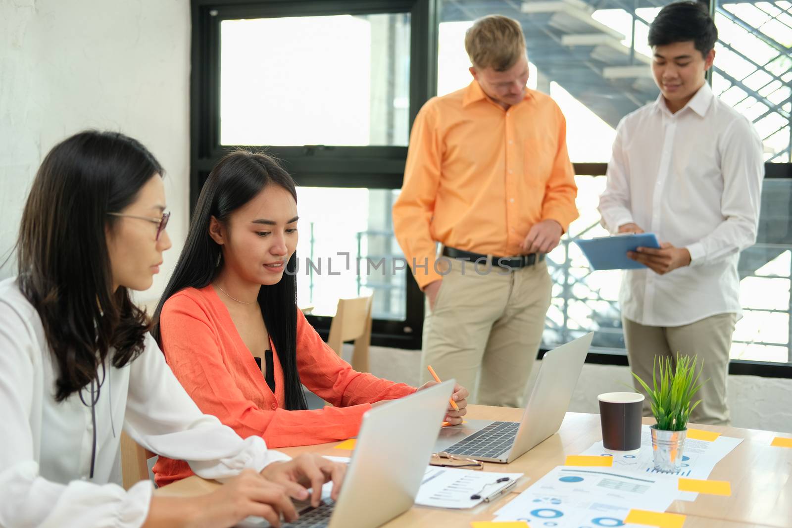 business people discussing on performance revenue in meeting. businessman working with co-worker team. financial adviser analyzing data with investor.