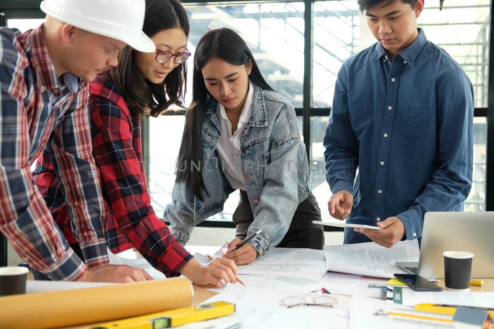 architect engineer interior designer team working discussing on house blueprint of real estate project in meeting. building construction teamwork concept