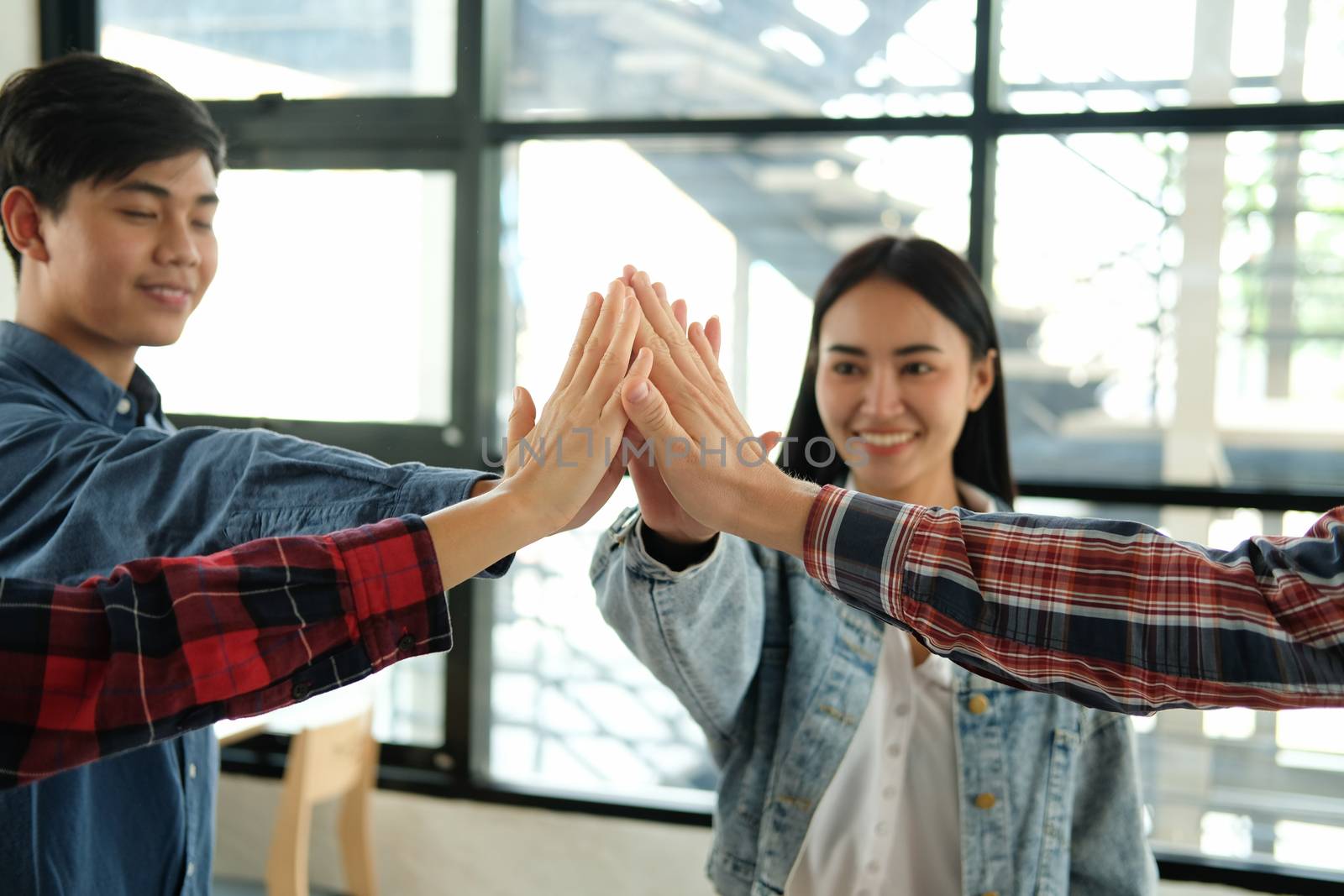 startup man woman joining united hand, business team touching hands together after complete a deal in meeting. unity teamwork partnership corporate concept.