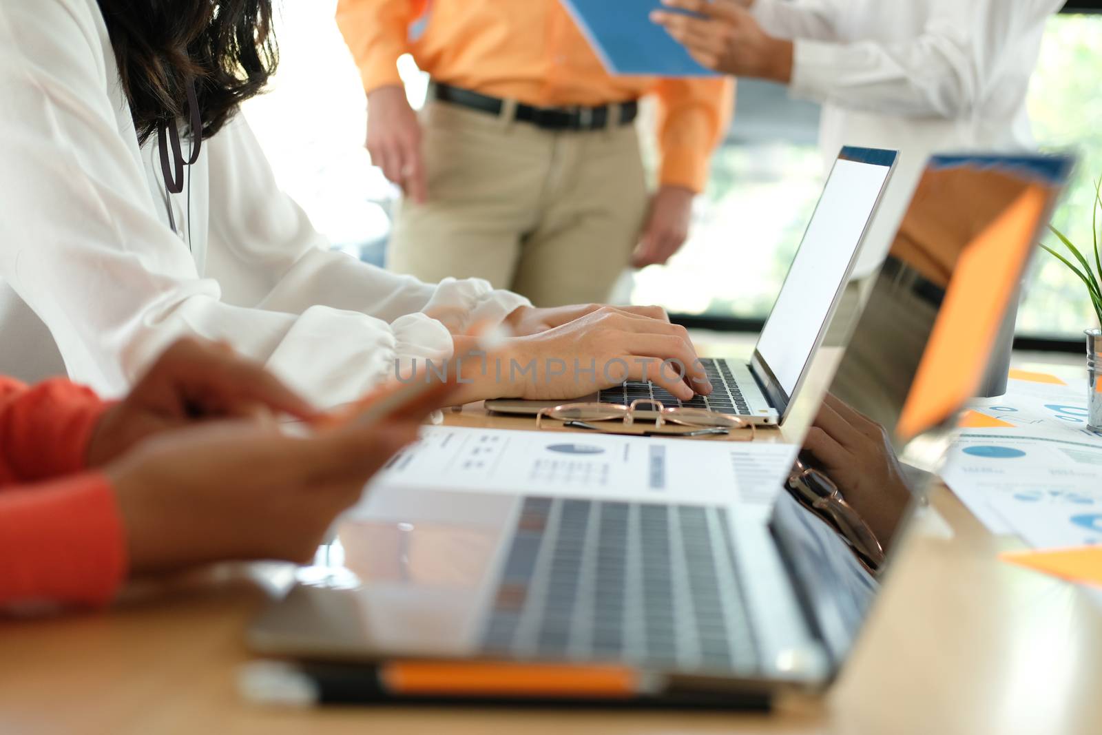 business people discussing on performance revenue in meeting. businessman working with co-worker team. financial adviser analyzing data with investor.