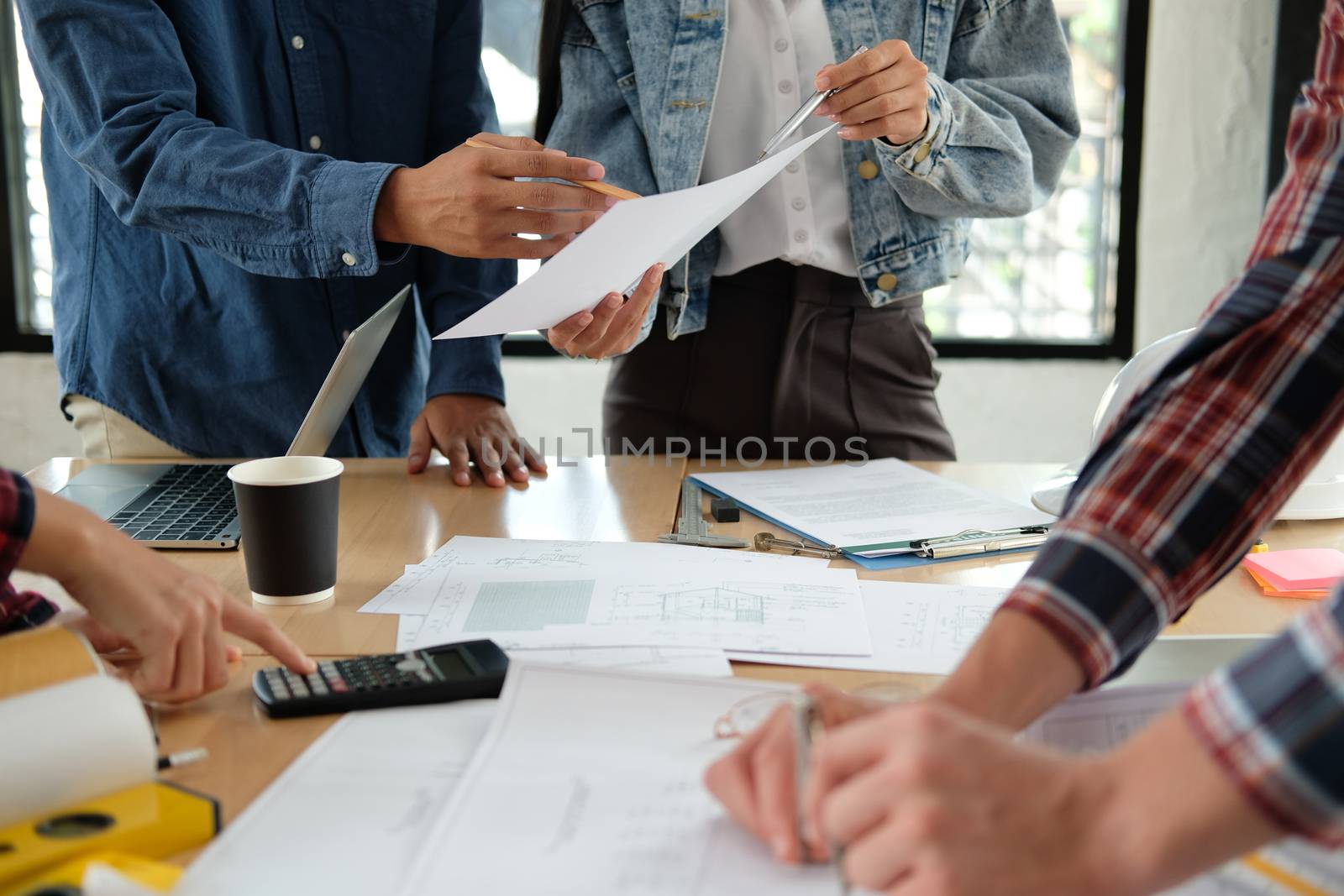 architect engineer interior designer team working discussing on house blueprint of real estate project in meeting. building construction teamwork concept