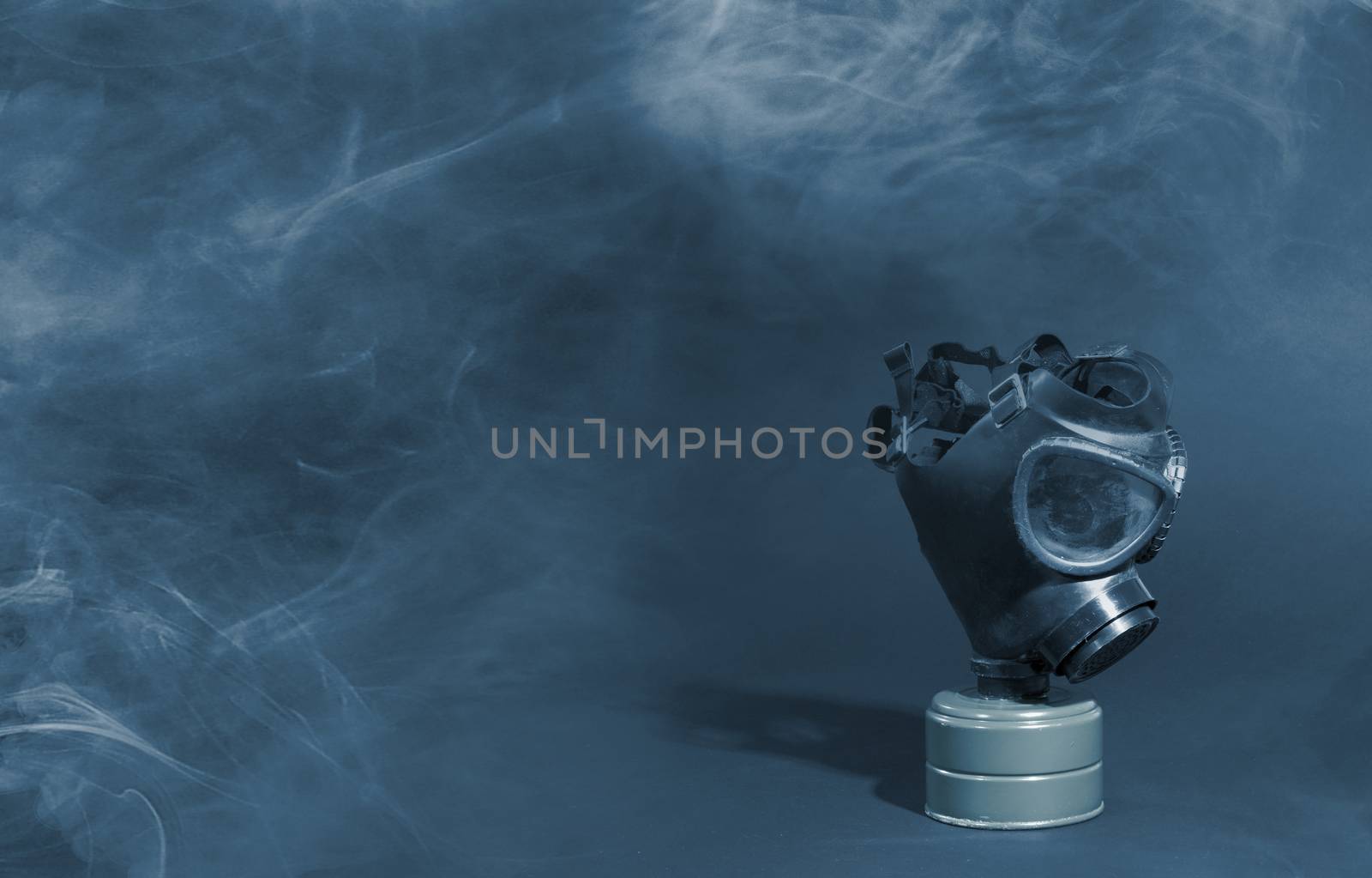 Vintage gasmask isolated on black background - Blue smoke in the room