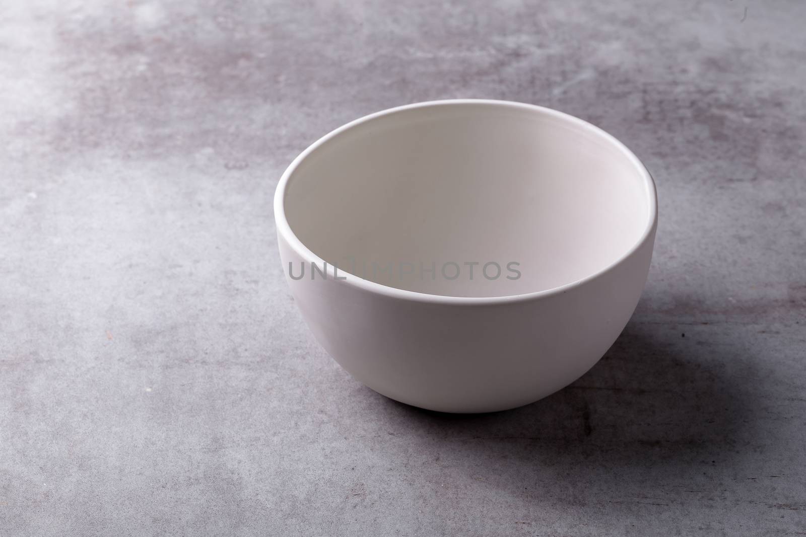 Empty blank white ceramic Bowl on Cement Board by kaiskynet