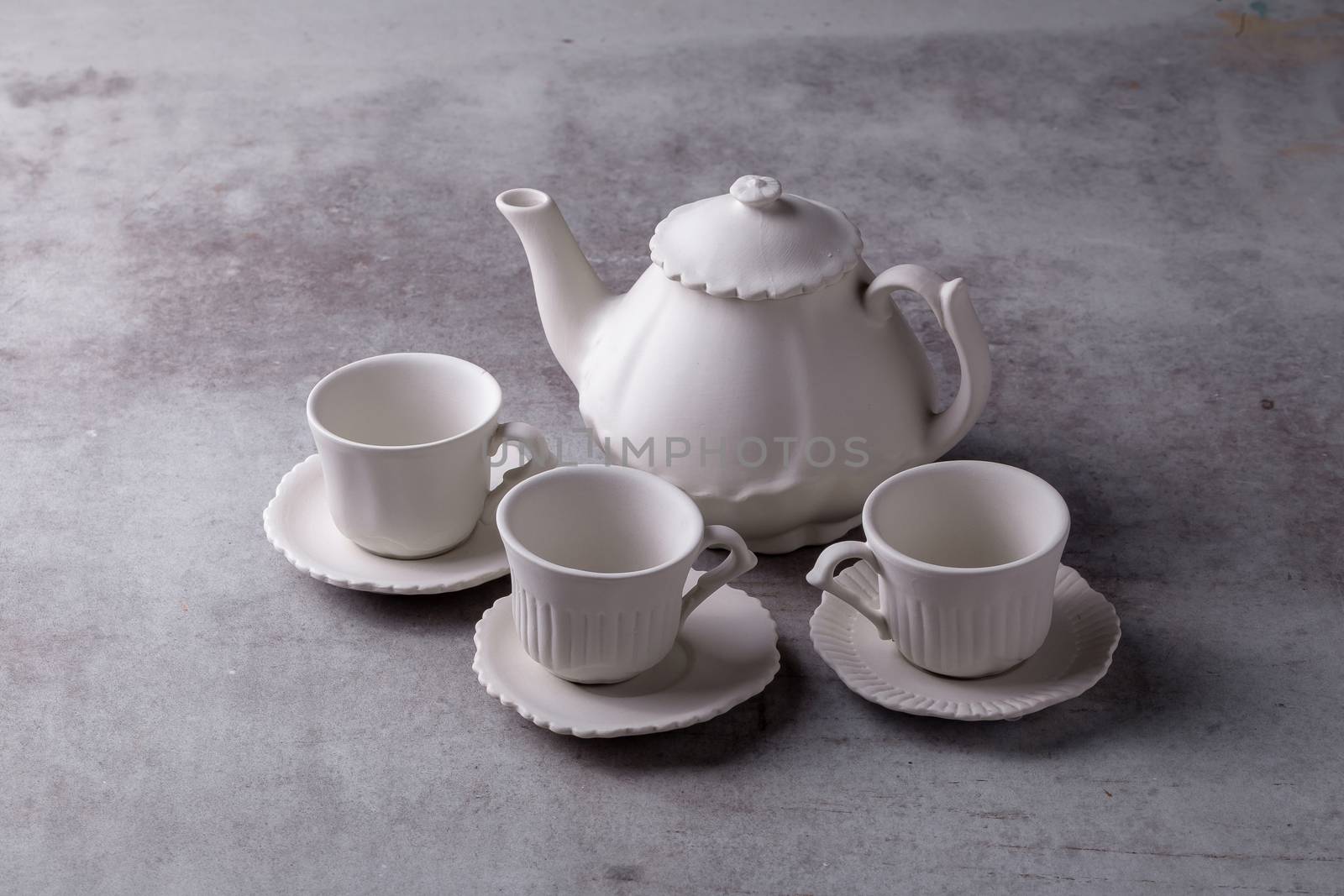 Teapot creamer, Cup and saucer on Cement Board.