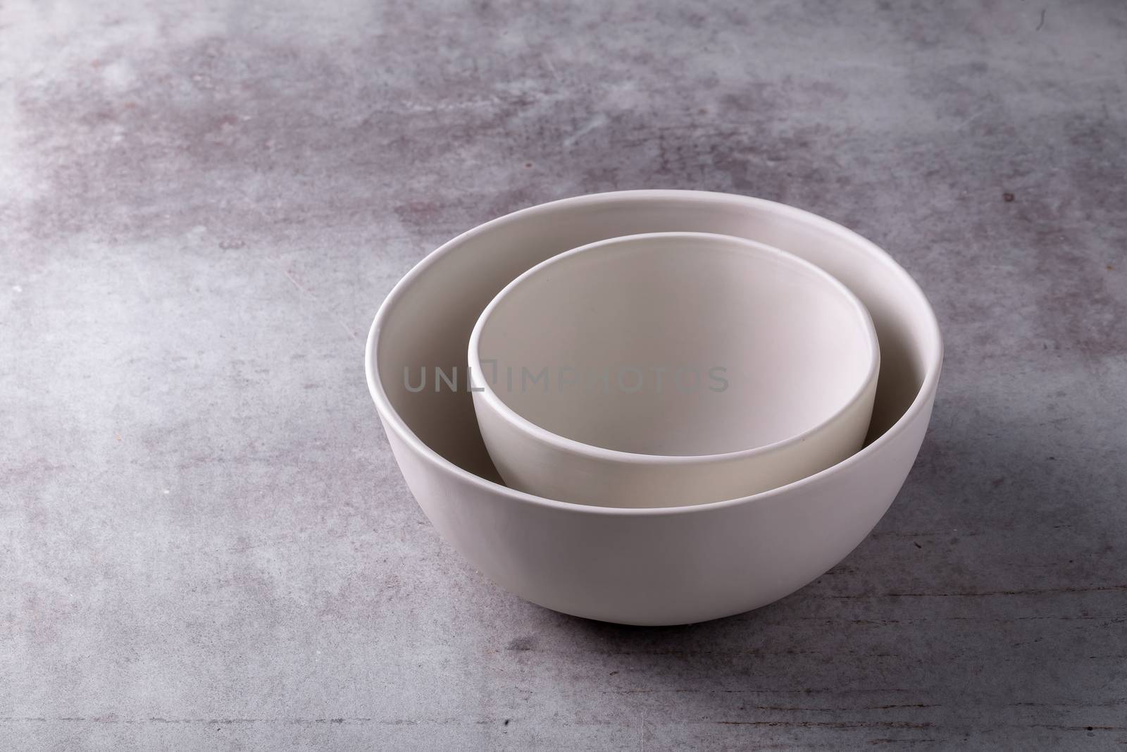 Empty blank white ceramic Bowl on Cement Board by kaiskynet