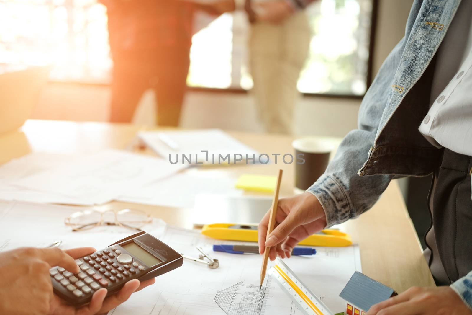 architect engineer interior designer team working discussing on house blueprint of real estate project in meeting. building construction teamwork concept