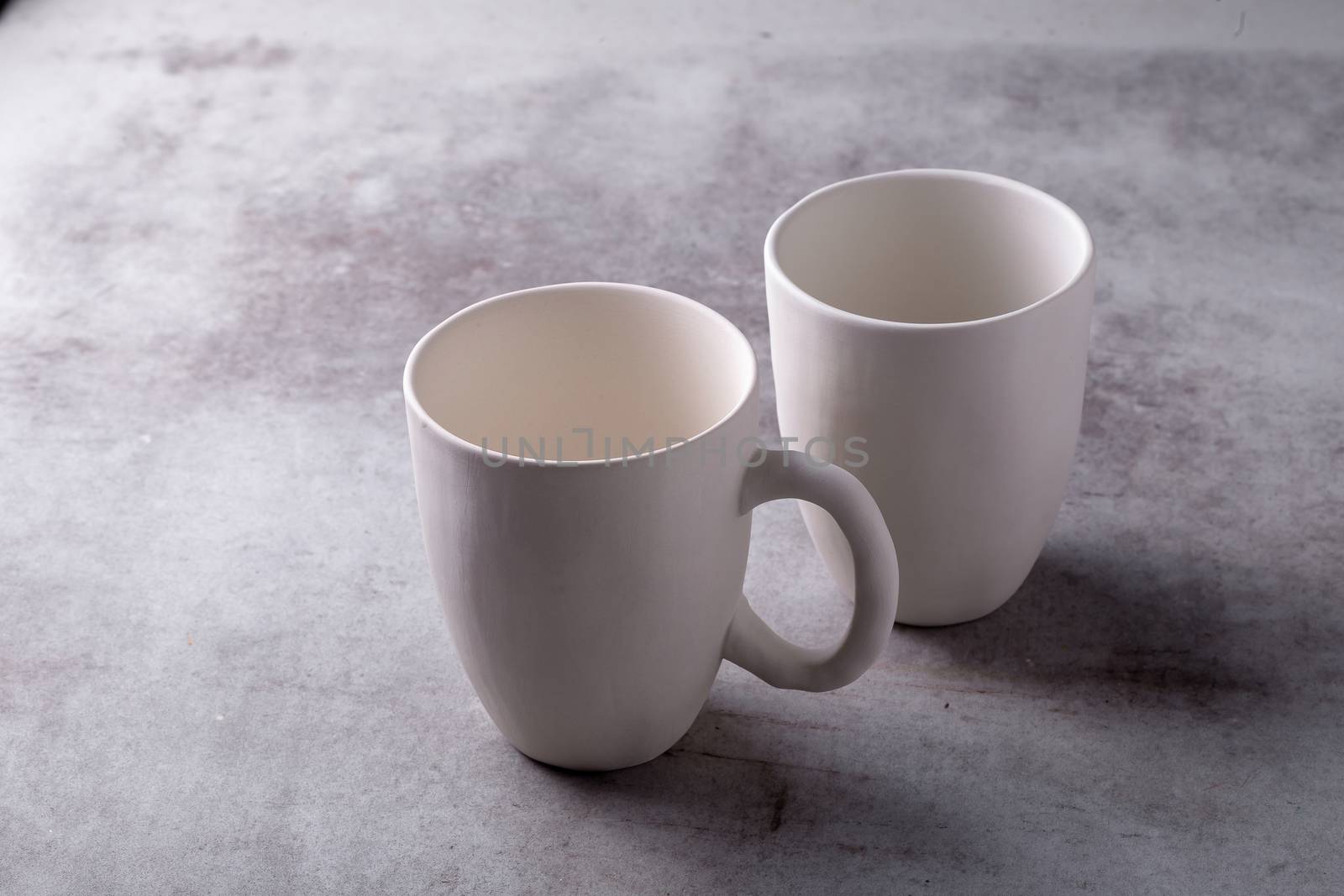 Empty blank white ceramic cup on Cement Board.