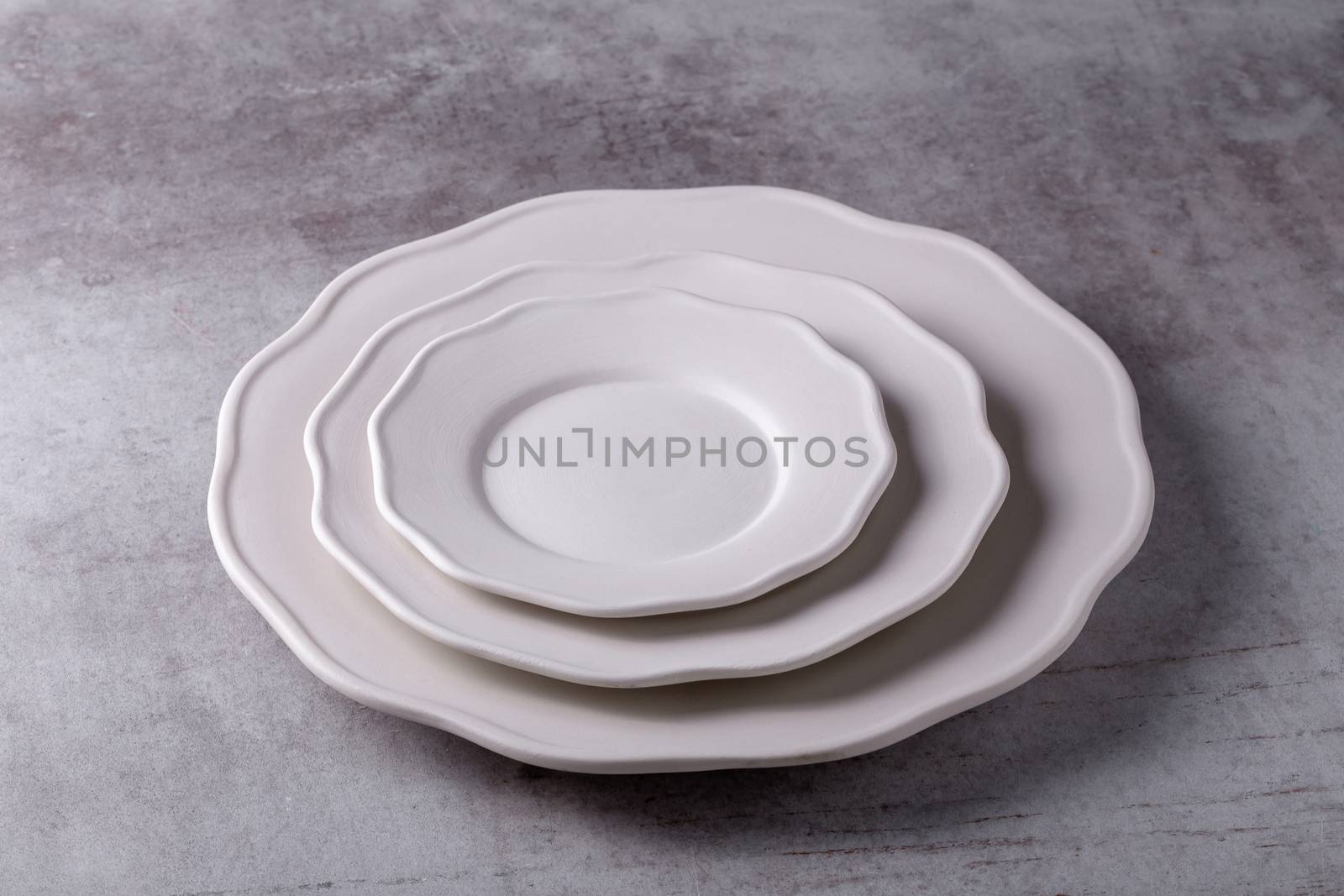 Empty blank white ceramic dish on Cement Board by kaiskynet