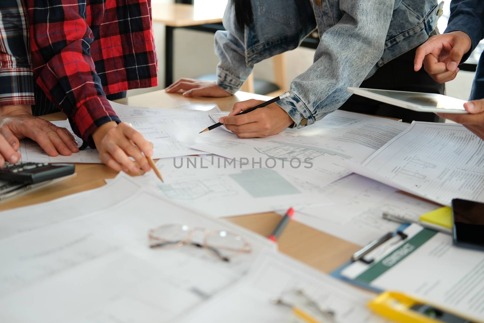 architect engineer interior designer team working discussing on house blueprint of real estate project in meeting. building construction teamwork concept