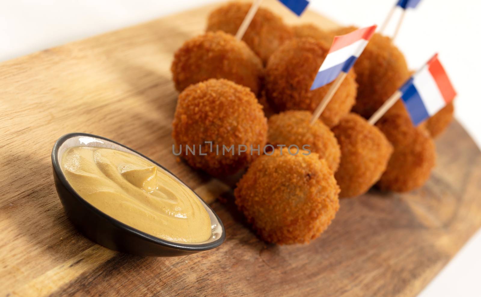 Dutch traditional snack bitterbal on a serving board, dutch flag, isolated