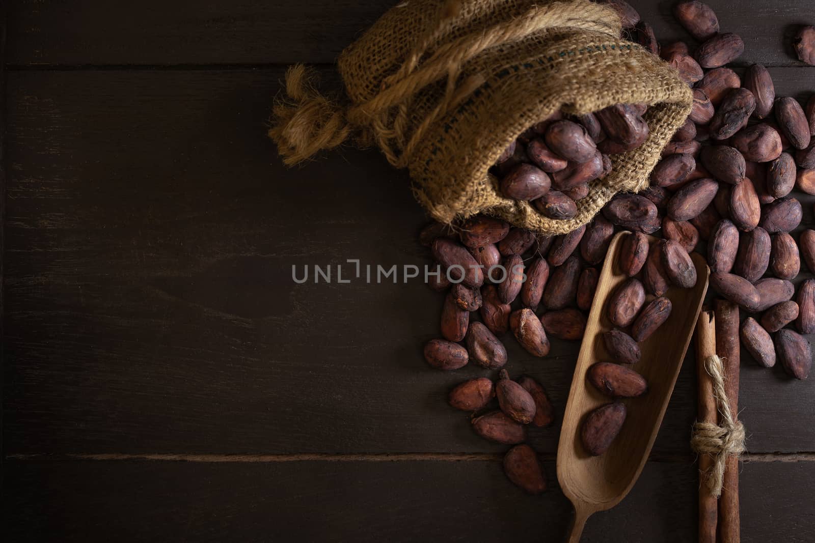 Top view of Cocoa beans in vintage table on dark background.