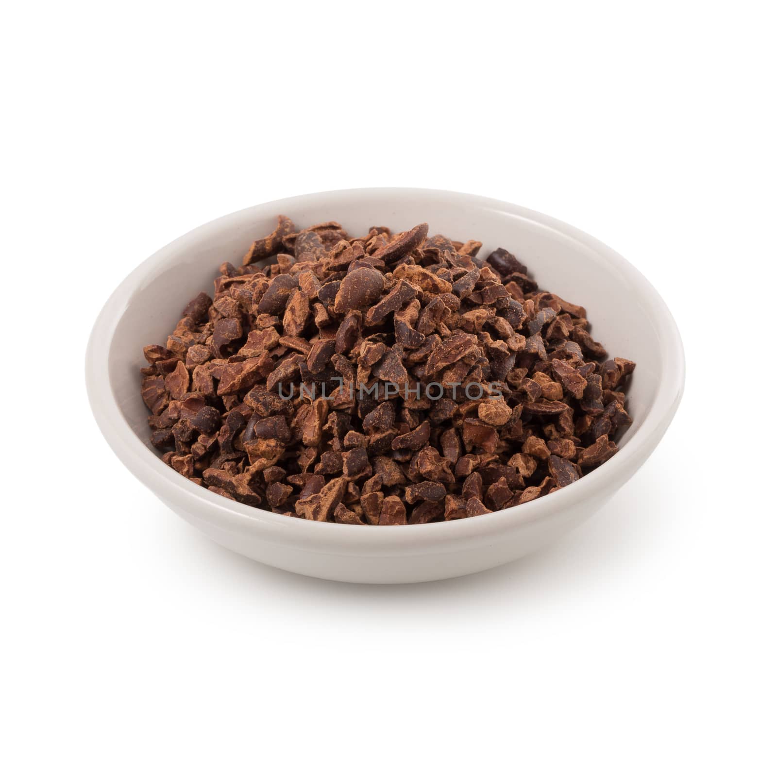 Bowl of cacao nibs isolated on a white background.