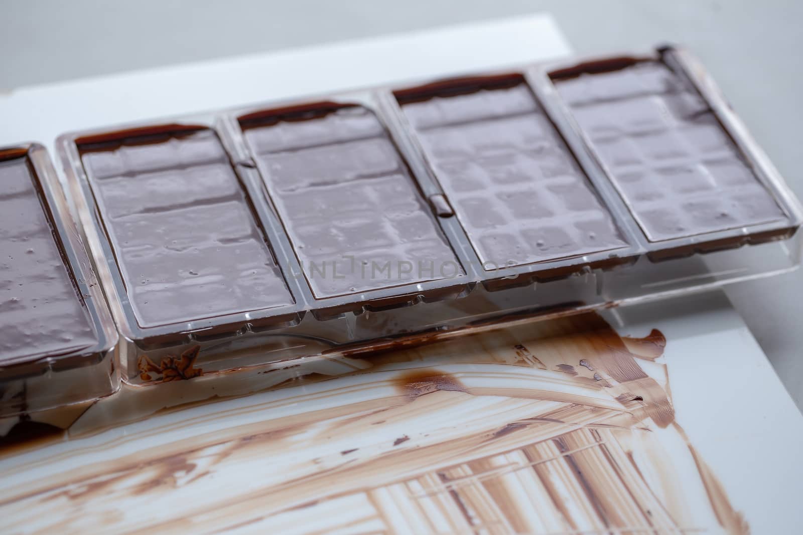 Preparation of dark chocolate bars made from scratch using cocoa butter and sugar.