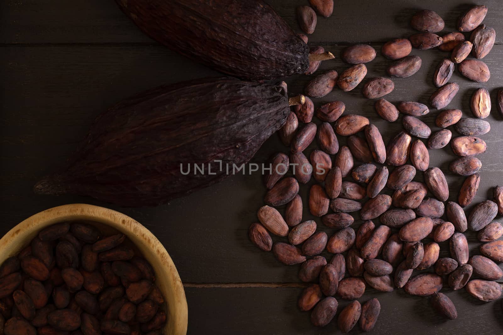 Top view of Cocoa beans in vintage table on dark background.