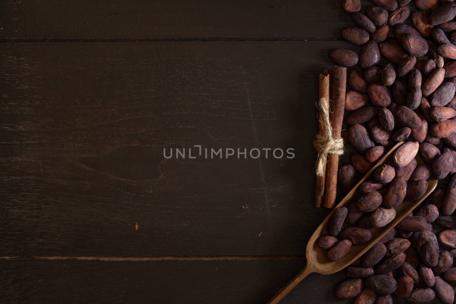 Top view of Cocoa beans in vintage table on dark background.