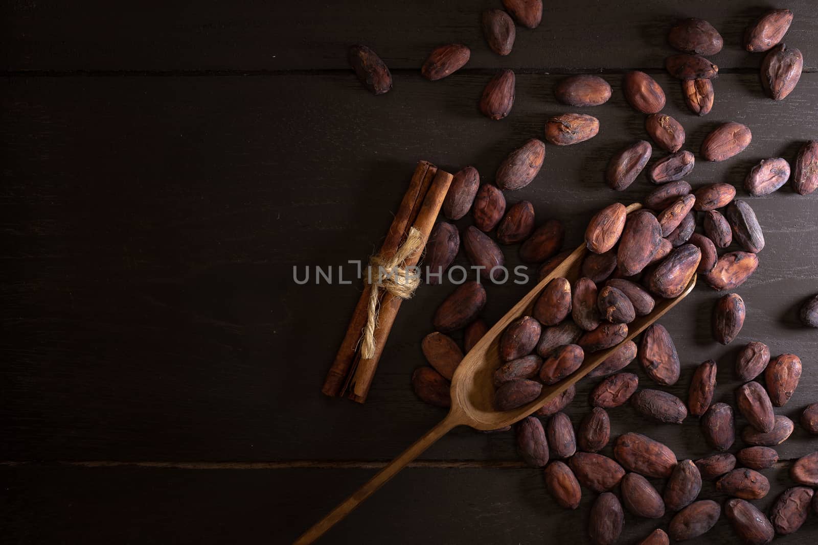 Top view of Cocoa beans in vintage table on dark background by kaiskynet