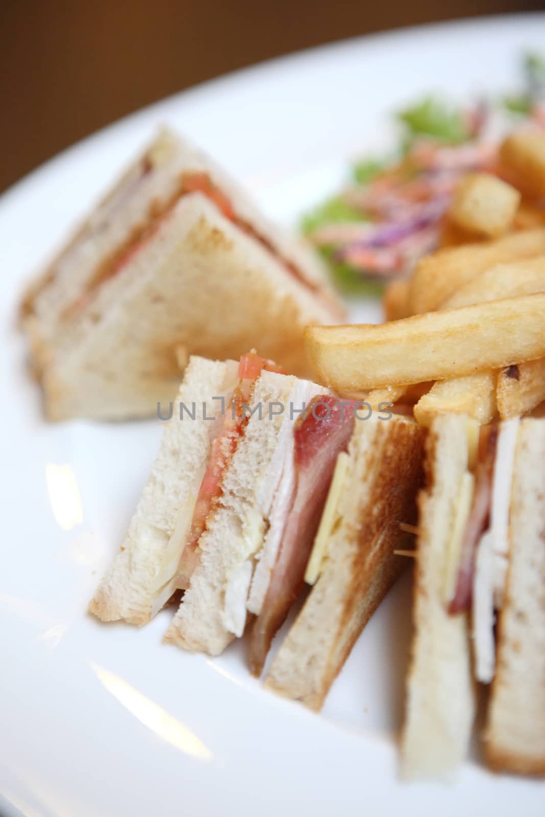 Club sandwich with coffee on wood background