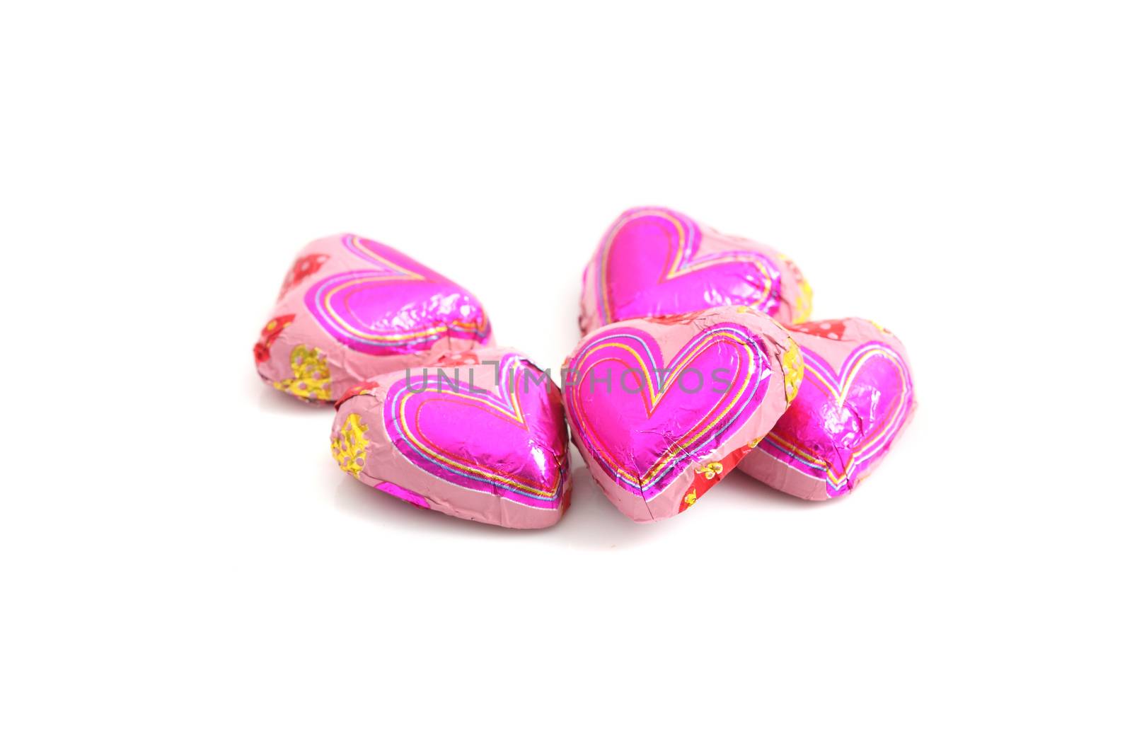 chocolate hearts candies isolated on white  by piyato