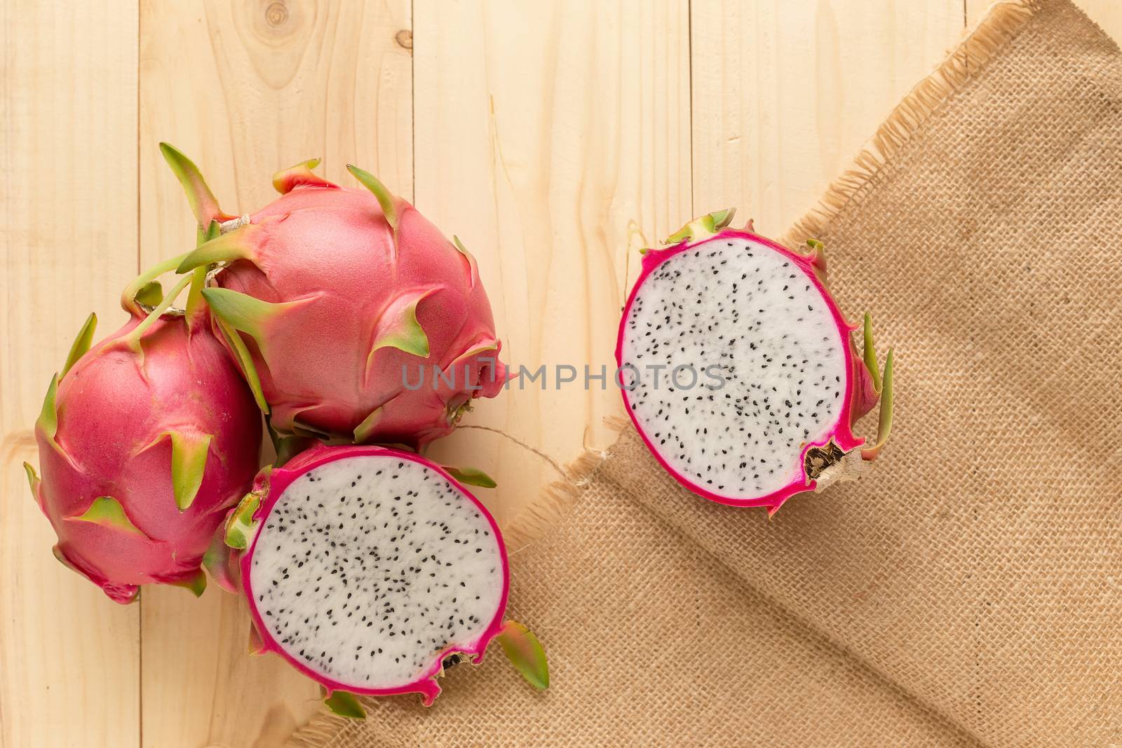 Tropical dragon fruit on wooden background. Top view.