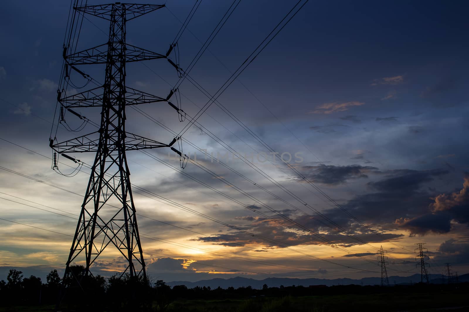 Colorful dramatic sky with Silhouette of high voltage pole and s by kaiskynet