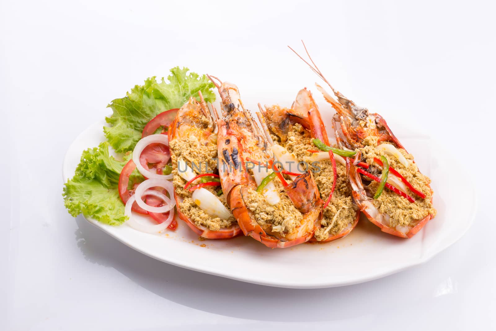 fried shrimp with curry in a white plate