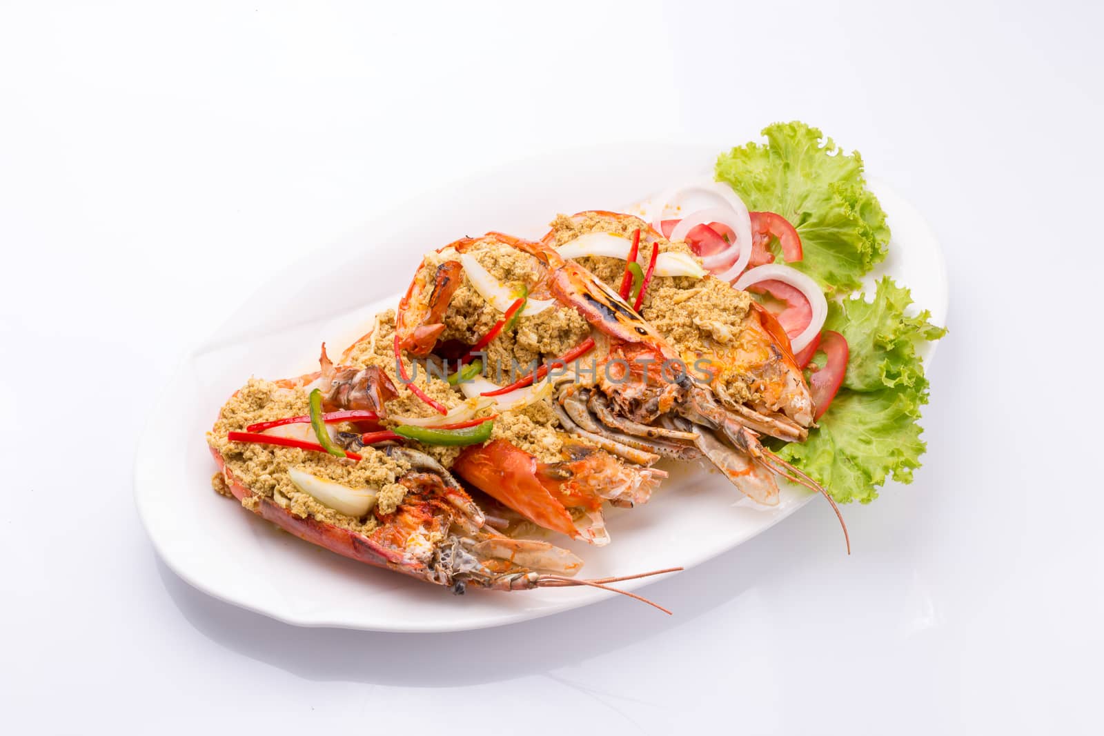 fried shrimp with curry in a white plate