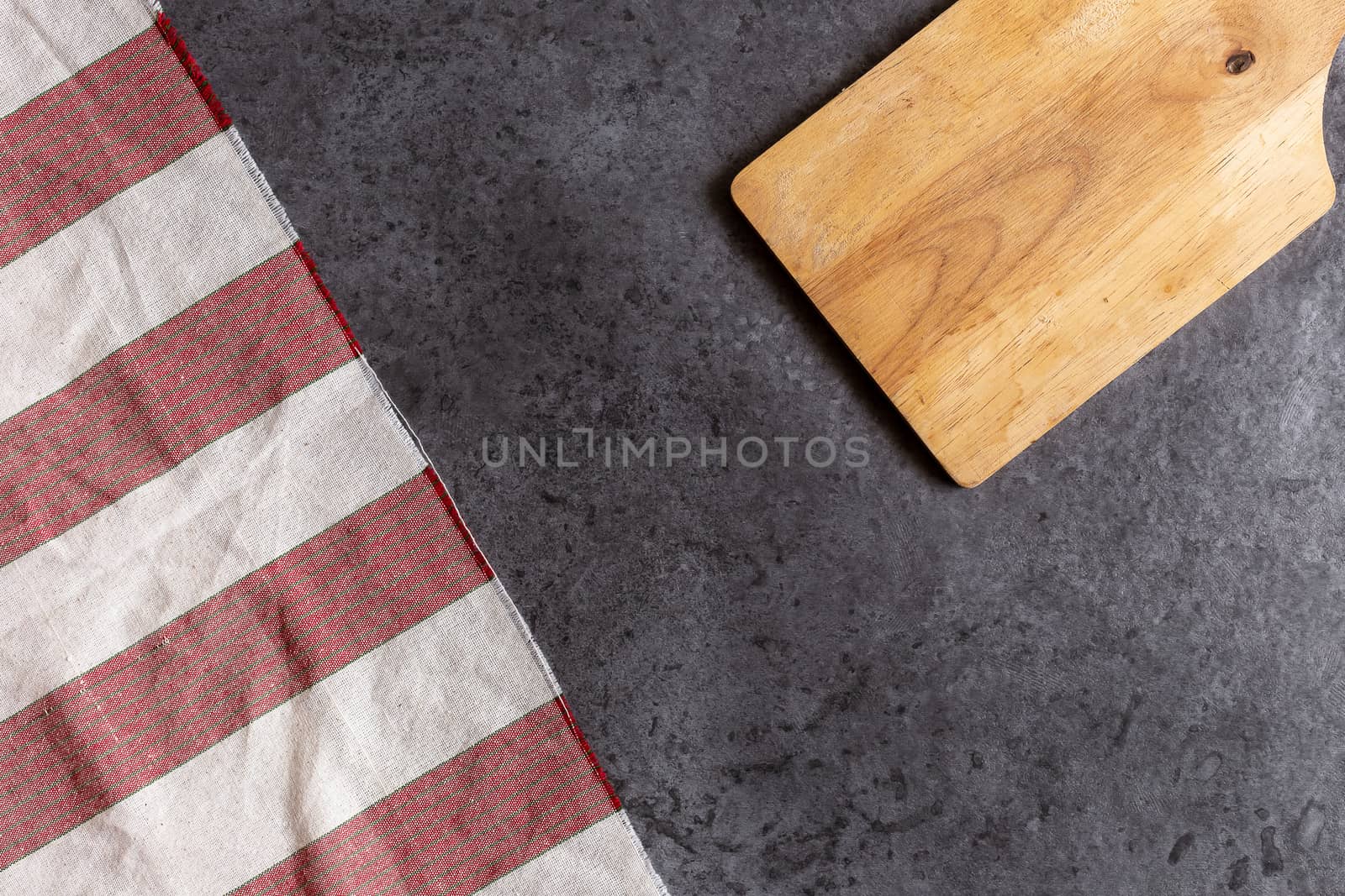 Wooden cutting board on black table background.