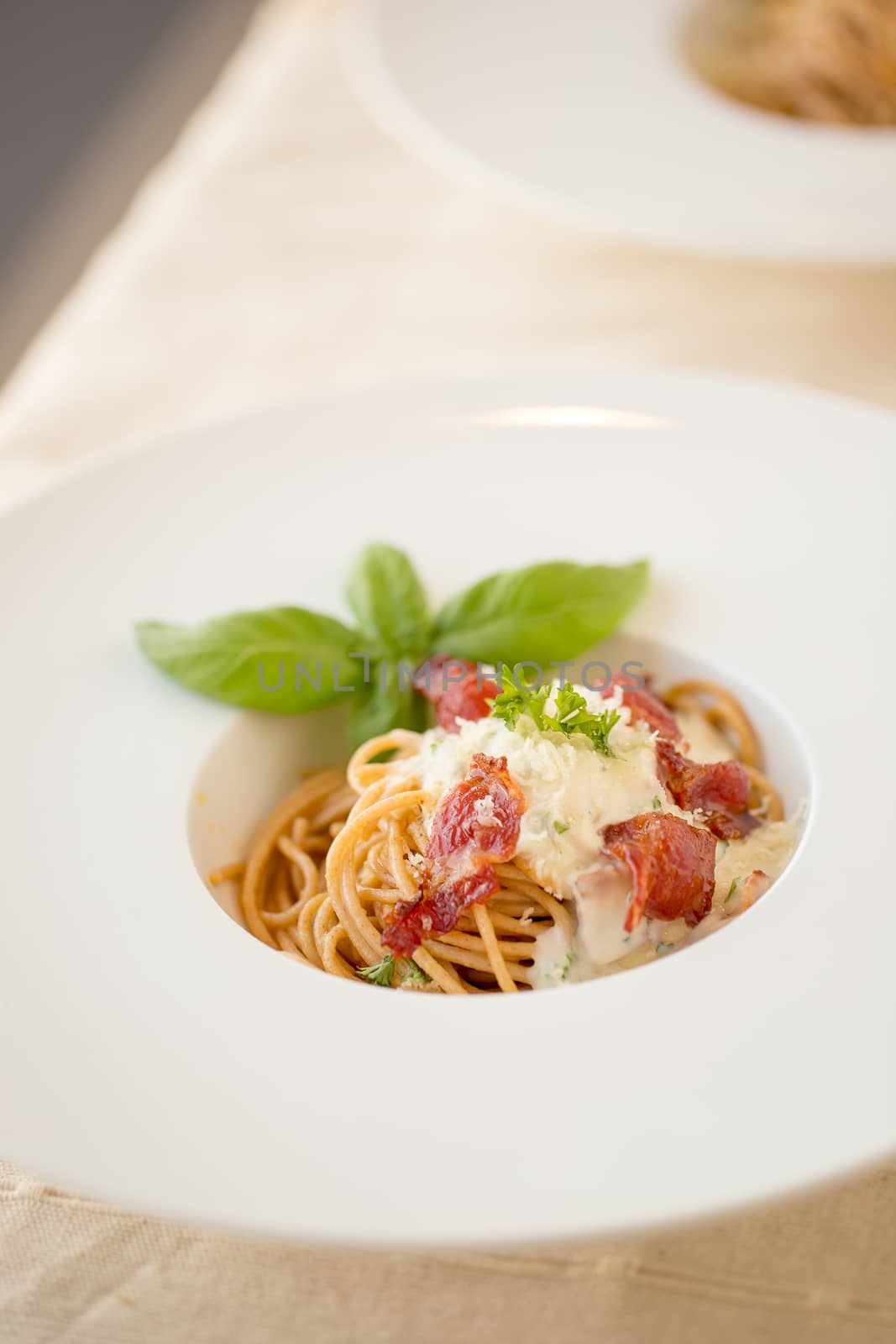 Spaghetti carbonara with bacon and cheese on white plate. by kaiskynet