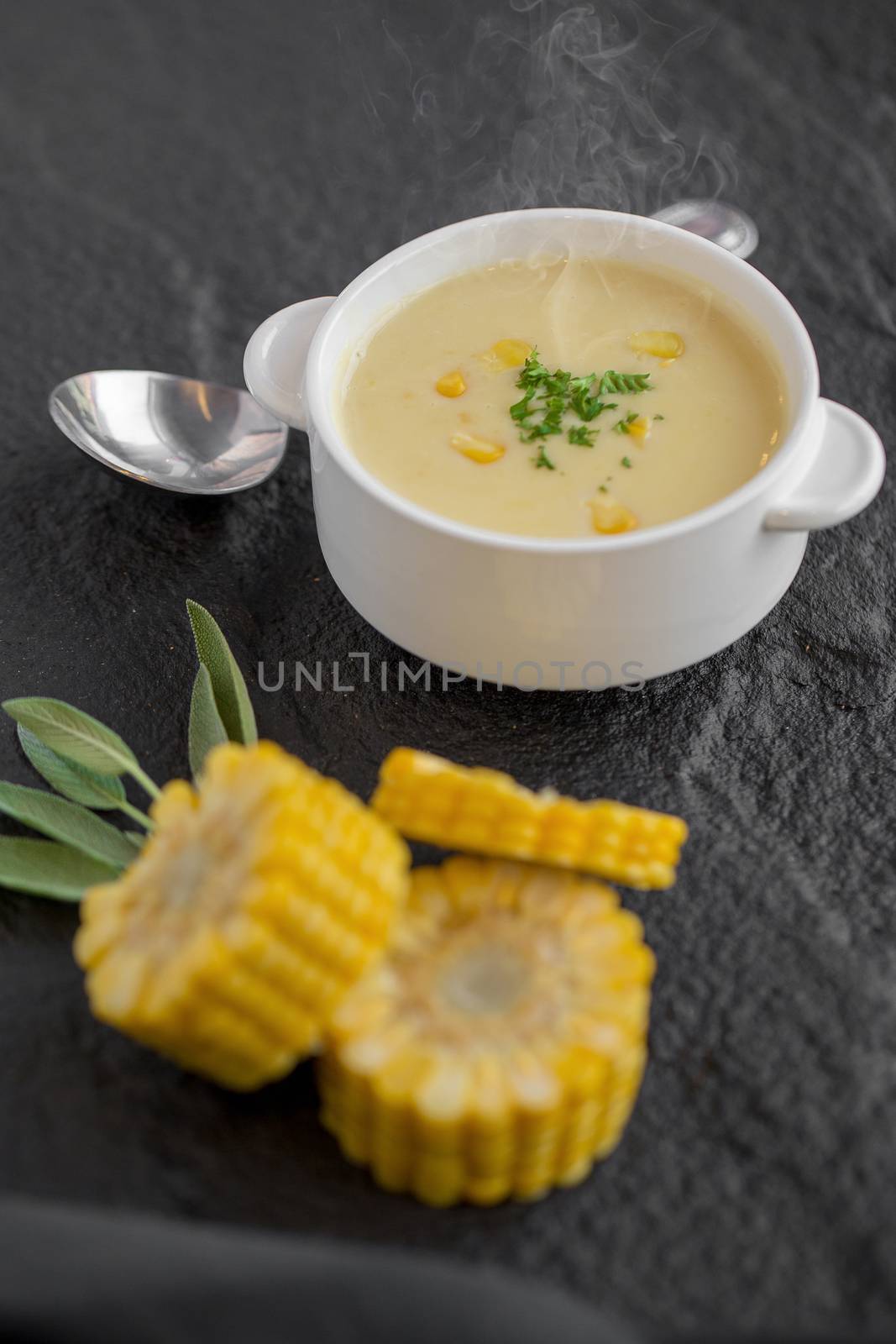 Corn soup in white cup on a table.