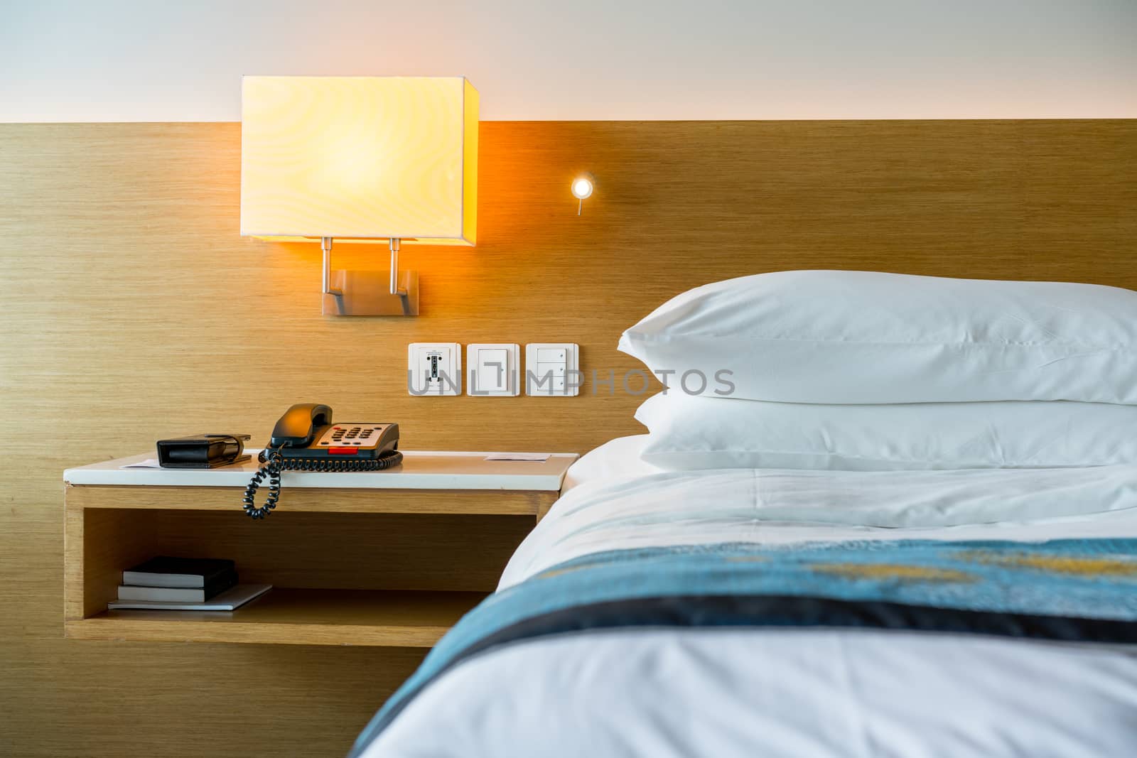 A hotel bedroom’s lamp for holiday by Alicephoto