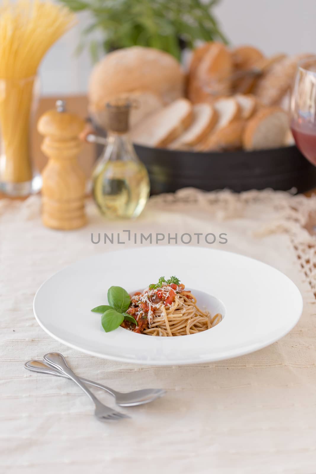 Spaghetti bolognese sauce with beef or pork,cheese,tomatoes and spices on white plate.