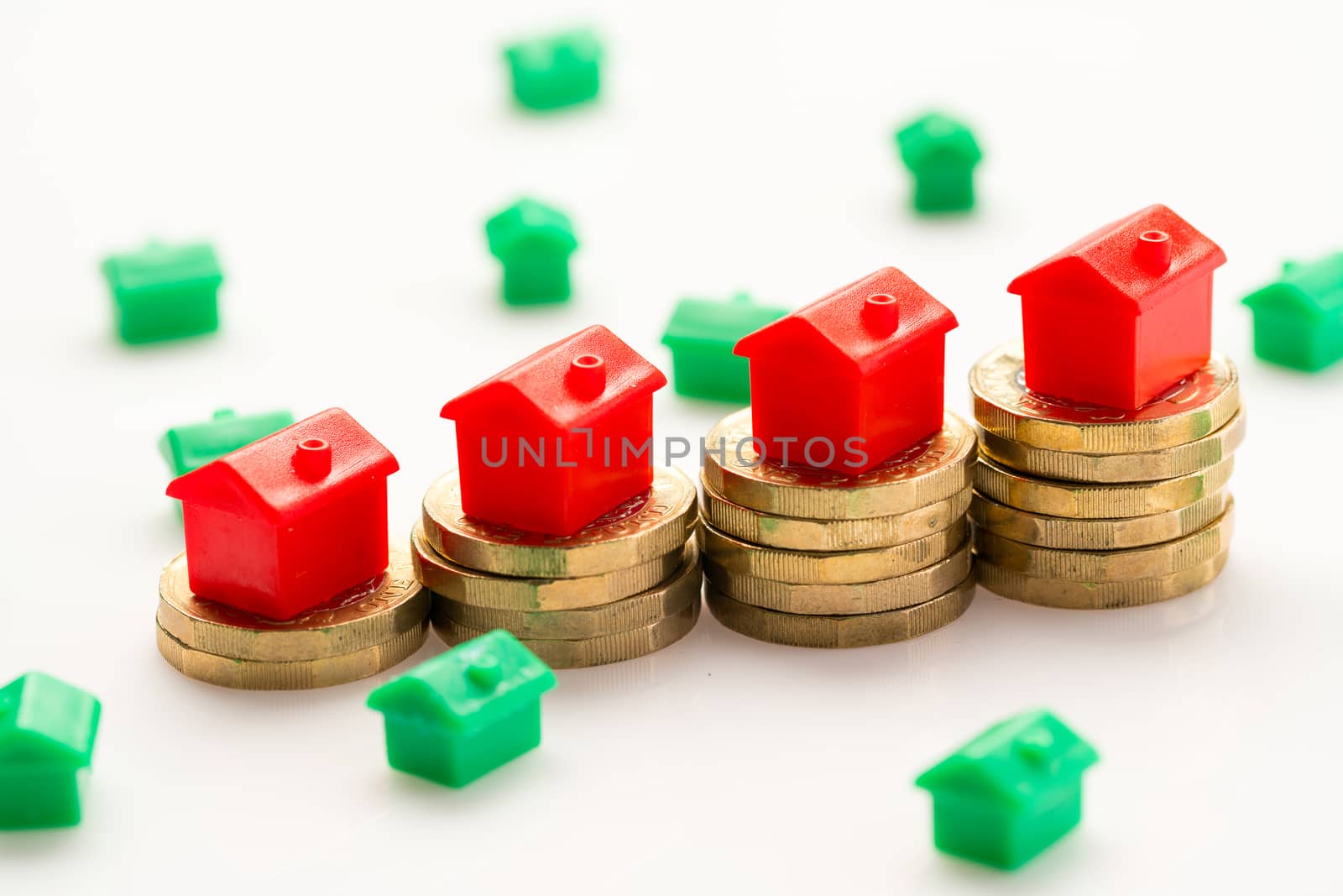 Housing estate concept with coins in studio by Alicephoto